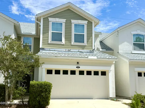 a view of a house with a backyard