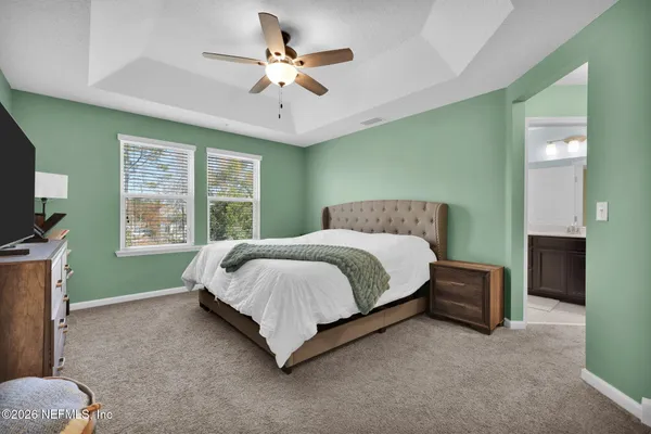 a bedroom with a bed and a chandelier