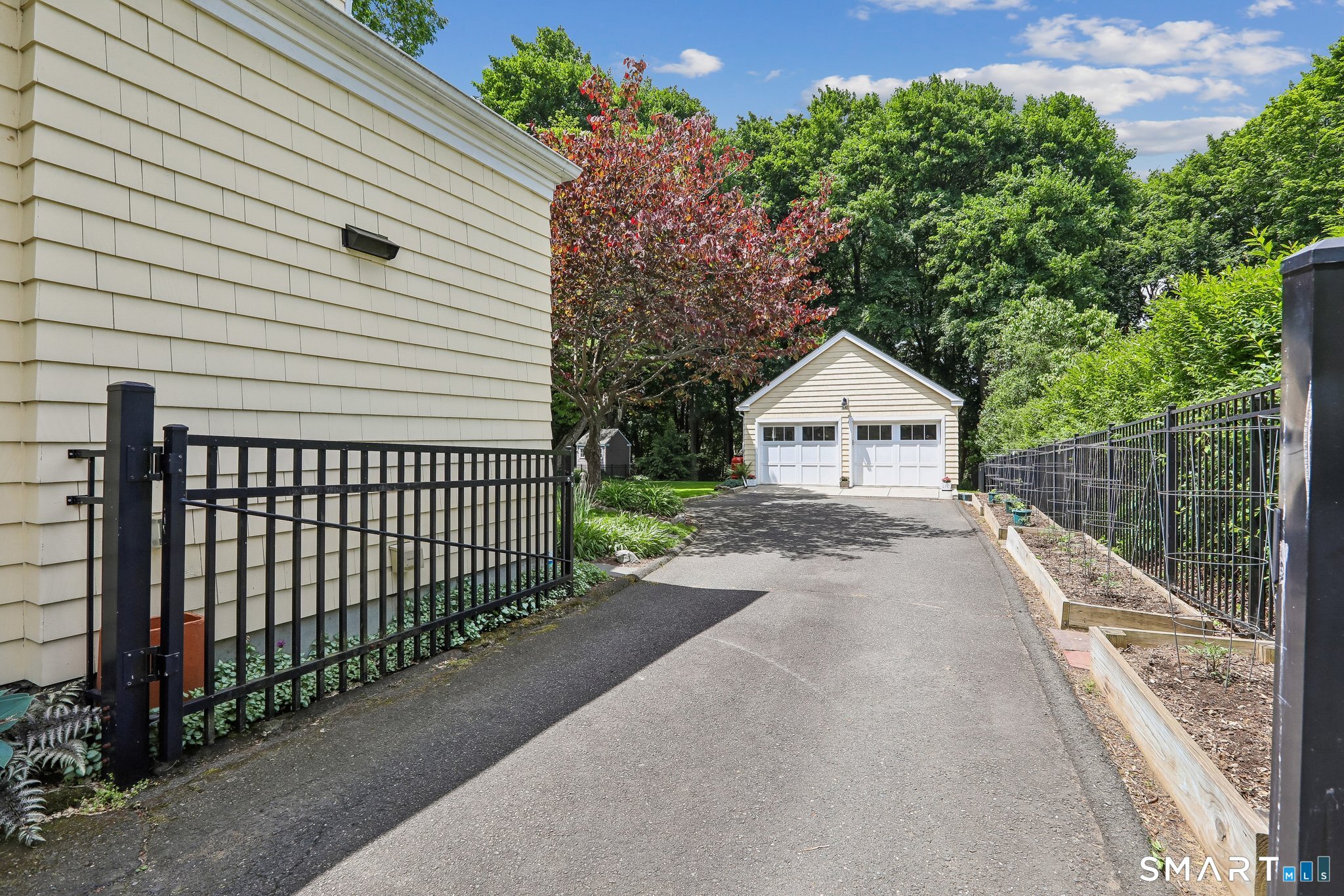 17 Ridge Road Danbury, CT 06810 - Photo 22 of 35 Driveway leading to back of house and oversized 2 car garage - gated and fenced back yard