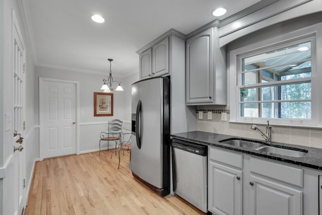 1440 Diamond Head Circle Decatur, GA 30033 - Photo 16 of 35 a kitchen with granite countertop a refrigerator sink and cabinets