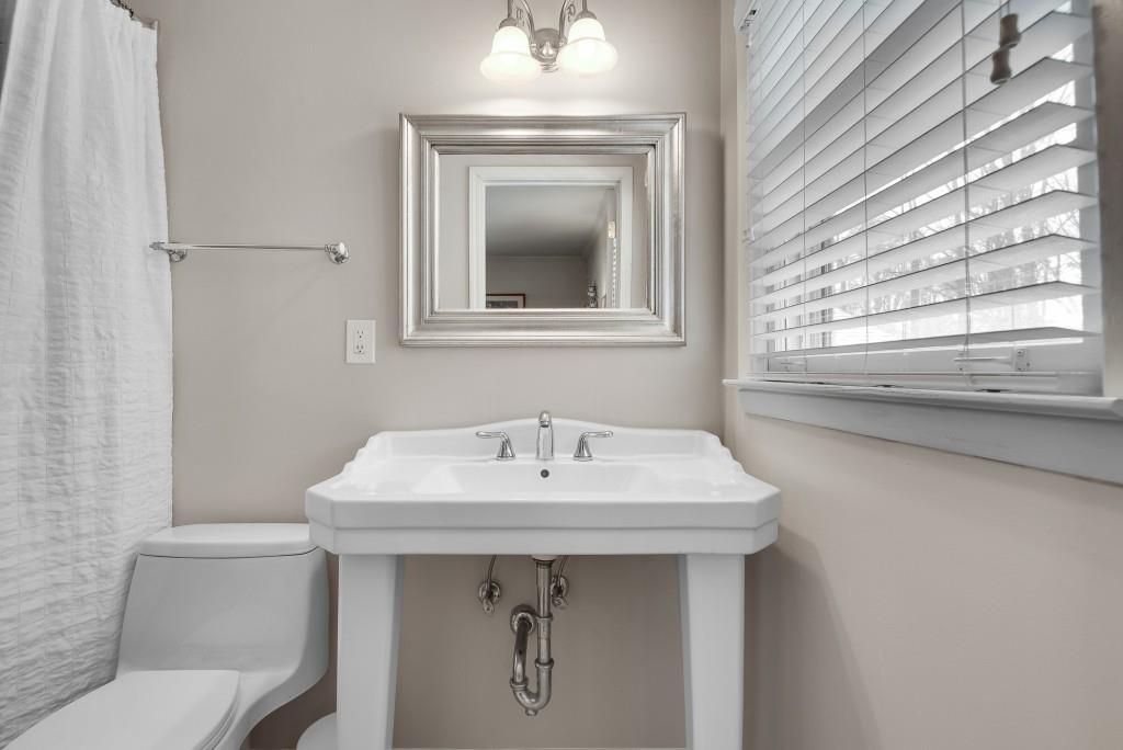 1440 Diamond Head Circle Decatur, GA 30033 - Photo 24 of 35 a bathroom with a sink a toilet and a window