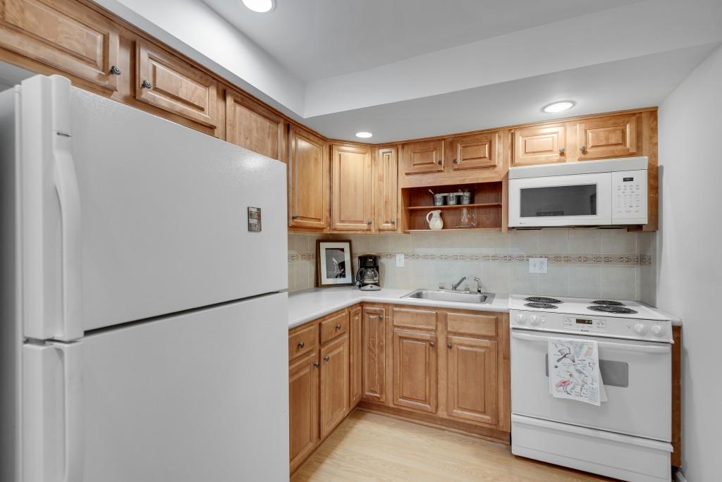 1440 Diamond Head Circle Decatur, GA 30033 - Photo 32 of 35 a kitchen with stainless steel appliances a refrigerator sink and microwave