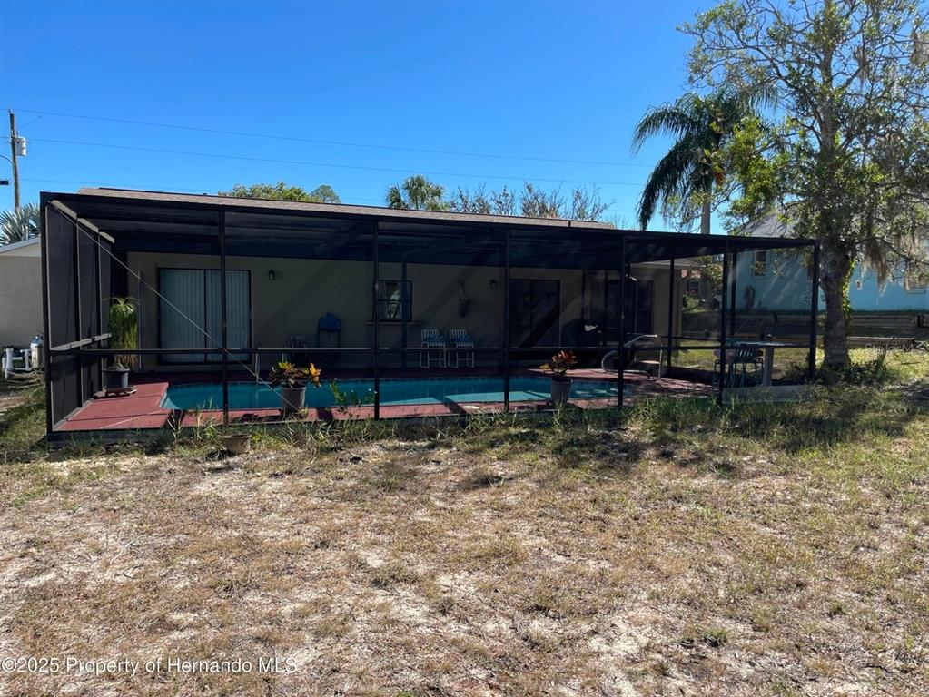 6233 Hancock Avenue Spring Hill, FL 34608 - Photo 17 of 19 a view of a chair and table in a yard