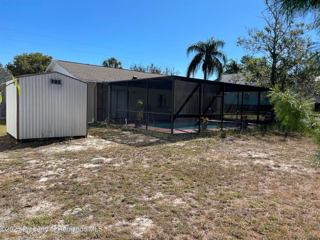 6233 Hancock Avenue Spring Hill, FL 34608 - Photo 19 of 19 a view of a house with a backyard and furniture