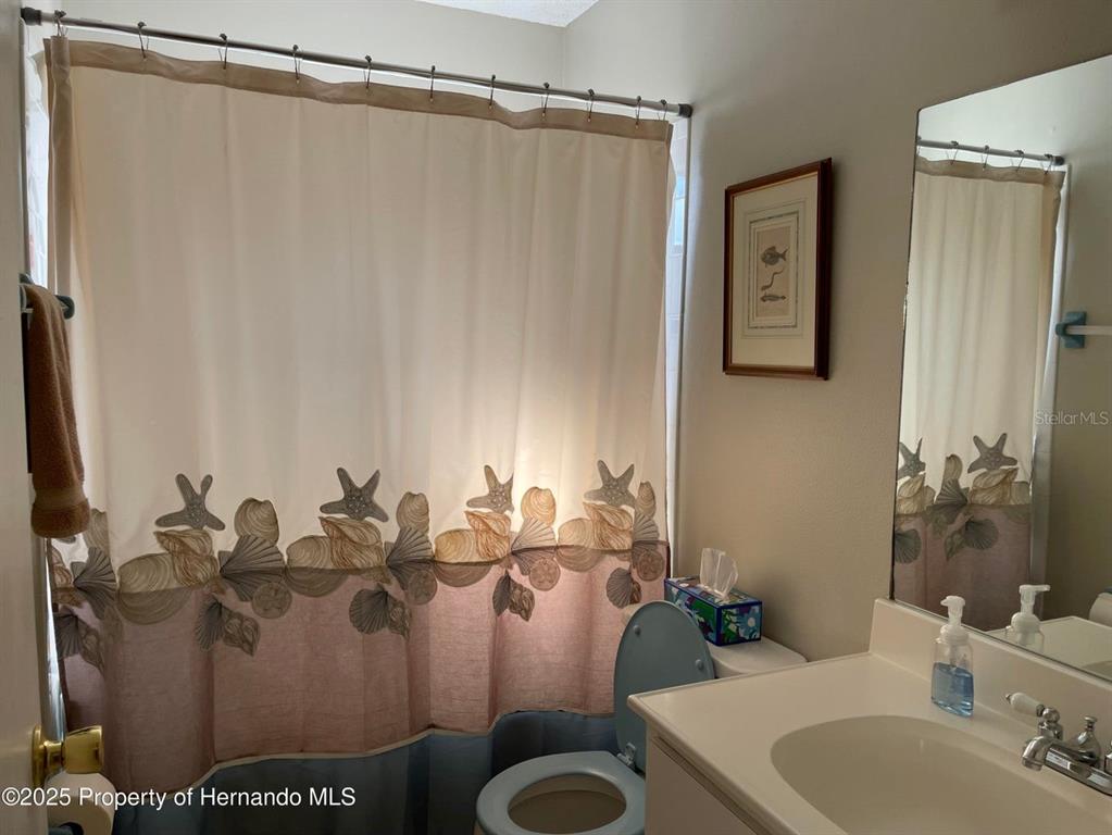 6233 Hancock Avenue Spring Hill, FL 34608 - Photo 7 of 19 a bathroom with a sink toilet and shower