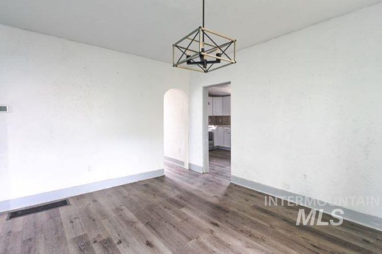 622 West Commercial Street Weiser, ID 83672 - Photo 11 of 21 Unfurnished dining area with arched walkways and dark wood finished floors