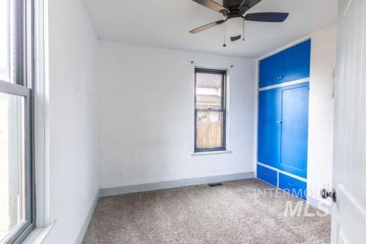 622 West Commercial Street Weiser, ID 83672 - Photo 5 of 21 Carpeted spare room featuring baseboards and a ceiling fan