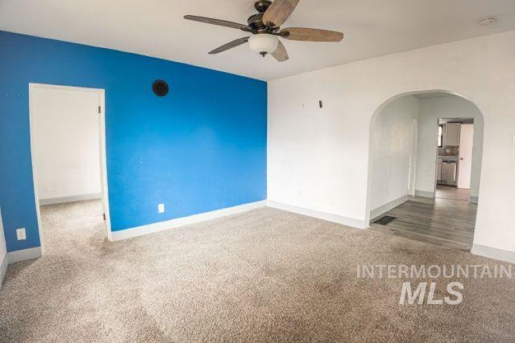 622 West Commercial Street Weiser, ID 83672 - Photo 7 of 21 Spare room featuring carpet, ceiling fan, and arched walkways