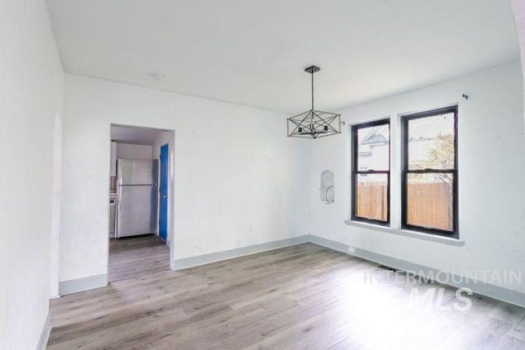 622 West Commercial Street Weiser, ID 83672 - Photo 10 of 21 Spare room with light wood finished floors and a chandelier