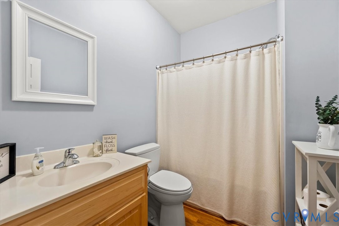 3060 Moyer Road Powhatan, VA 23139 - Photo 33 of 66 Bright bathroom featuring a wood-finish vanity wit