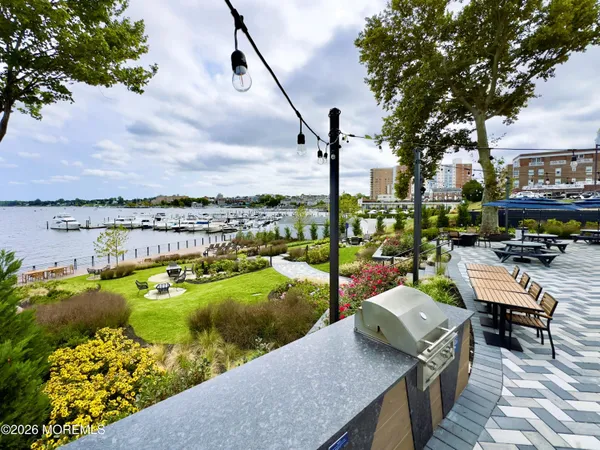 a view of a lake with couches and city view