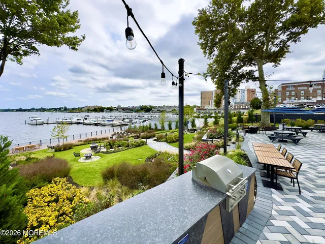 a view of a lake with couches and city view