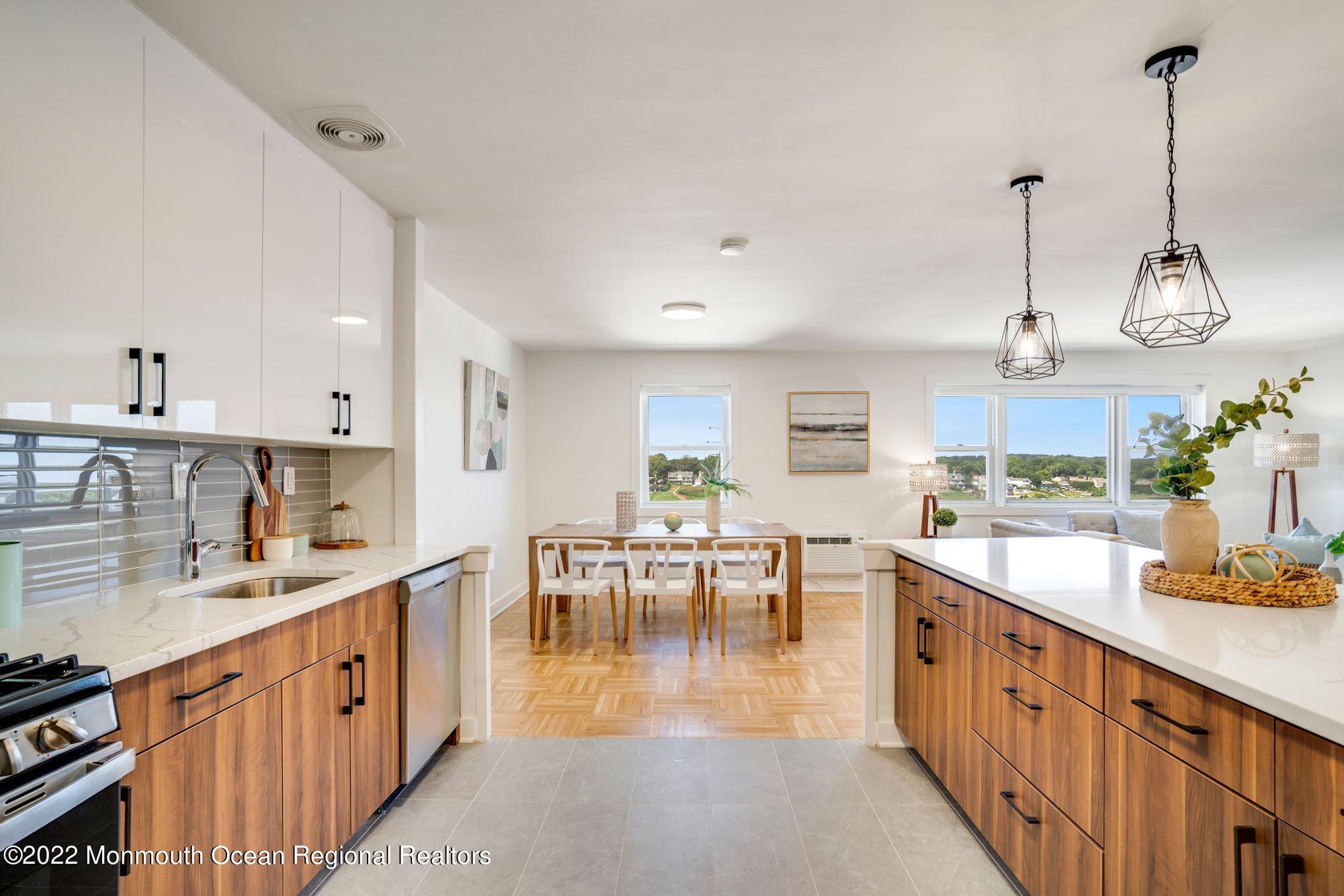 122 Bodman Place, Unit 6B Red Bank, NJ 07701 - Photo 18 of 30 a large kitchen with kitchen island lots of counter space dining table and chairs