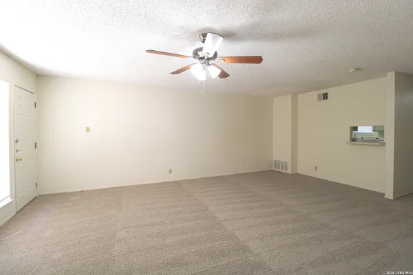 an empty room with closet and windows
