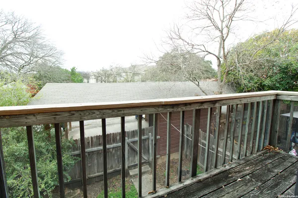 a balcony with wooden floor and fence