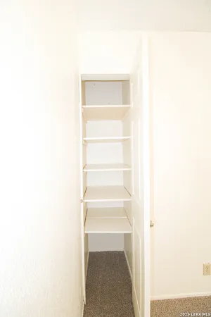 a view of staircase with white walls