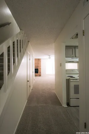 a view of a hallway with an entryway and livingroom