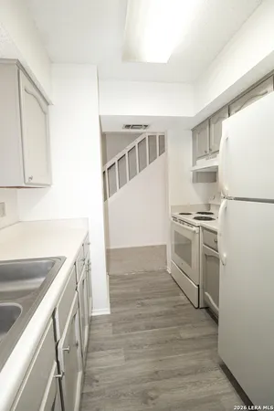 a kitchen with a refrigerator sink and stove