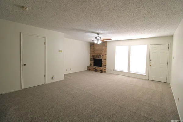 a view of an empty room with a chandelier