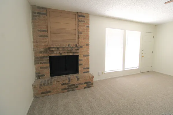 an empty room with a fireplace