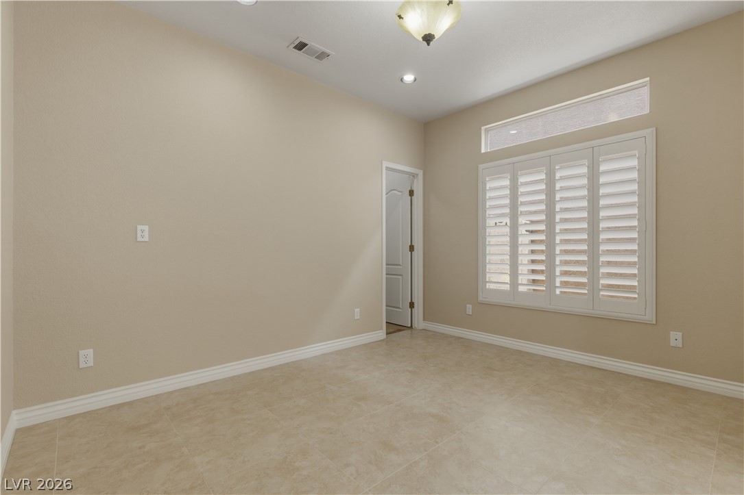 29 Olive Tree Henderson, NV 89074 - Photo 21 of 60 This versatile room features tiled flooring and bright windows, ready for personalization.