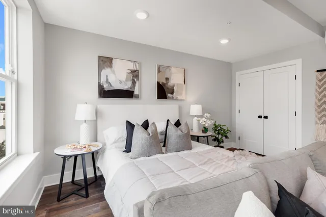 a bedroom with a bed and a painting on the wall