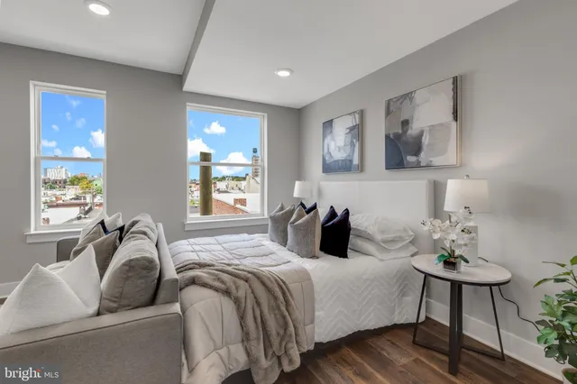 a bedroom with double bed and a couch