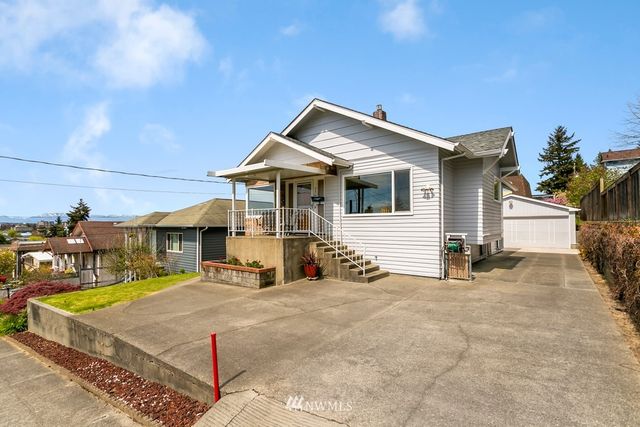 a view of a house with patio and a yard