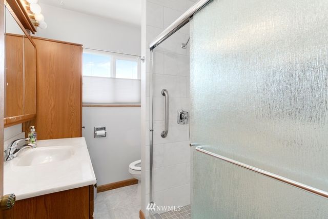 a bathroom with a sink a shower and a mirror