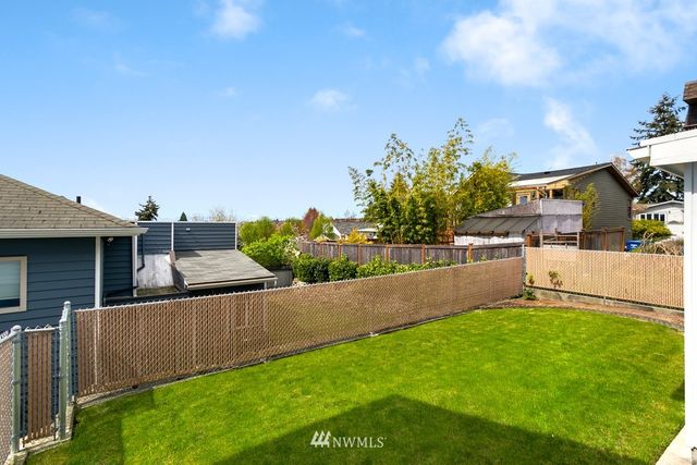 a view of a house with a yard and sitting area