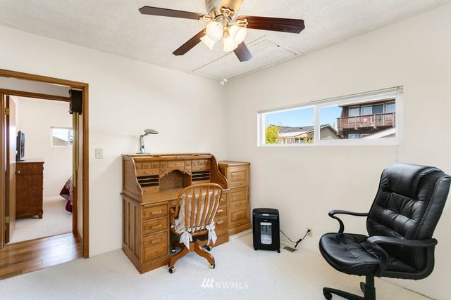 a view of workspace and bedroom with furniture