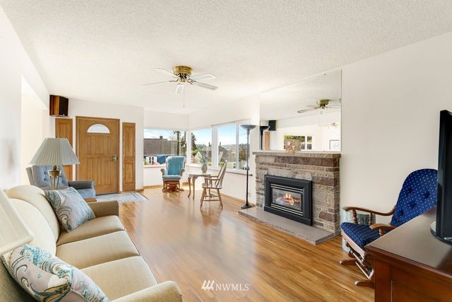 a living room with furniture fireplace and wooden floor
