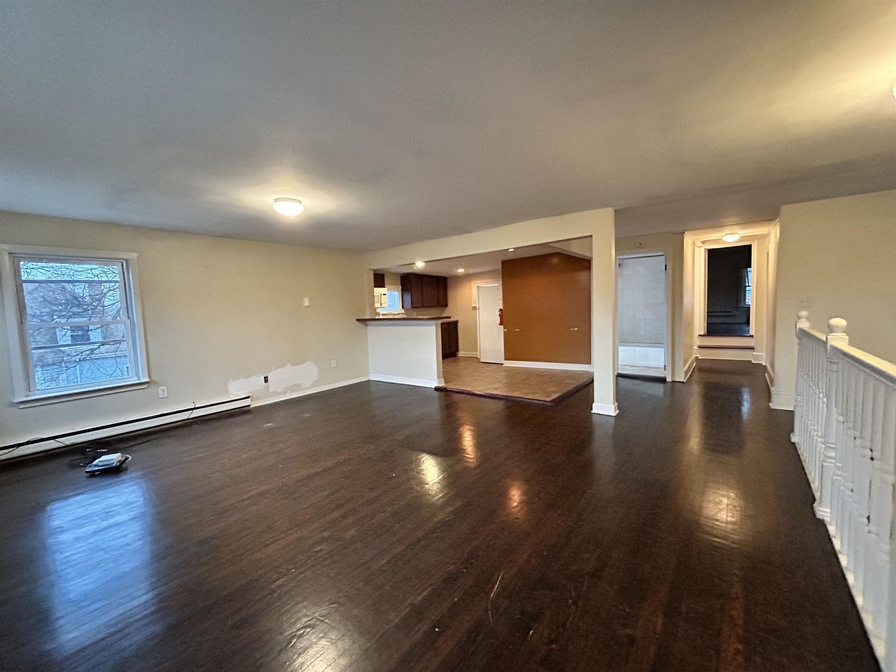 86 South Morris Street, Unit B Dover, NJ 07801 - Photo 5 of 11 an empty room with wooden floor and windows