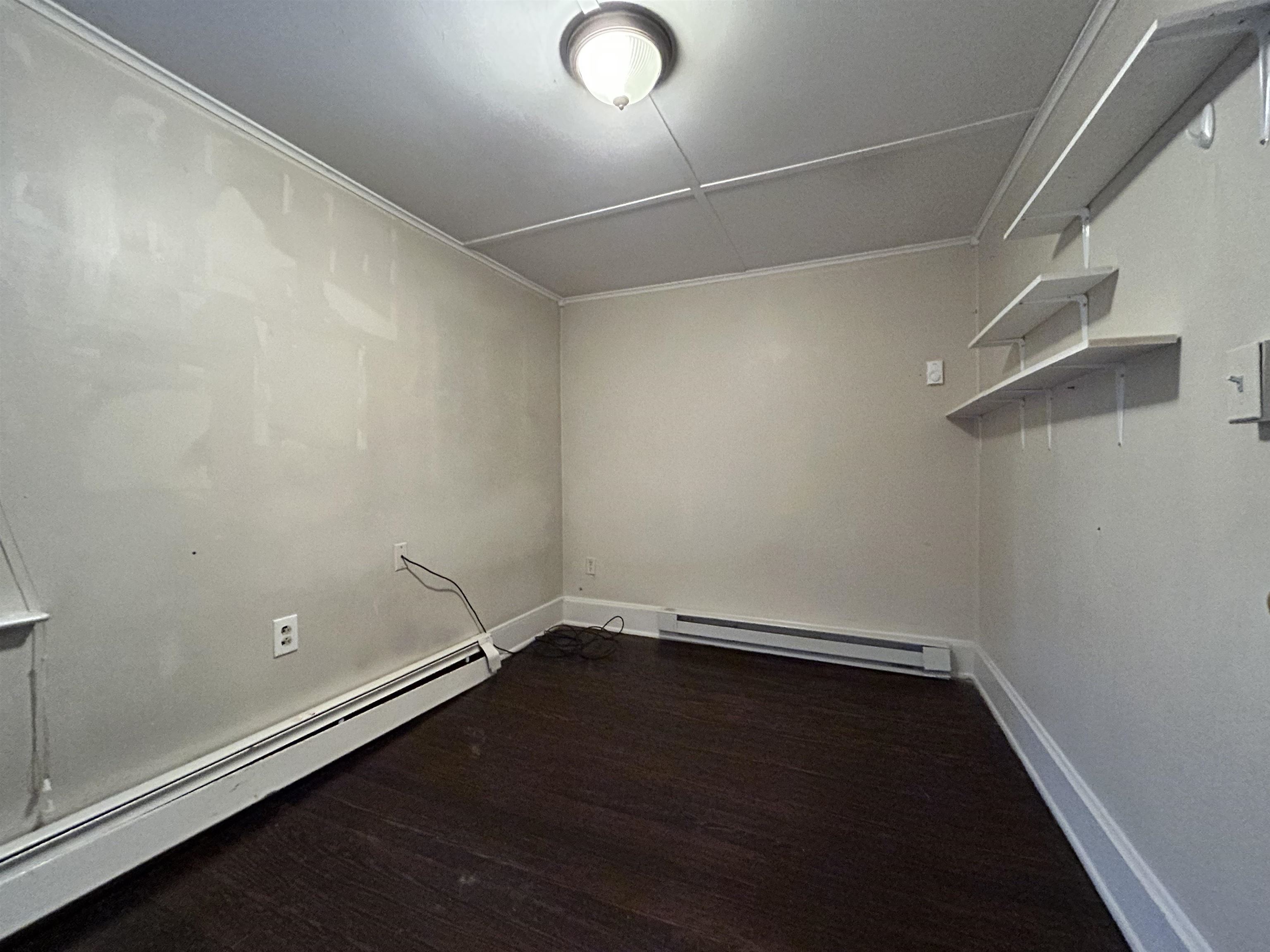 86 South Morris Street, Unit B Dover, NJ 07801 - Photo 9 of 11 an empty room with a workbench