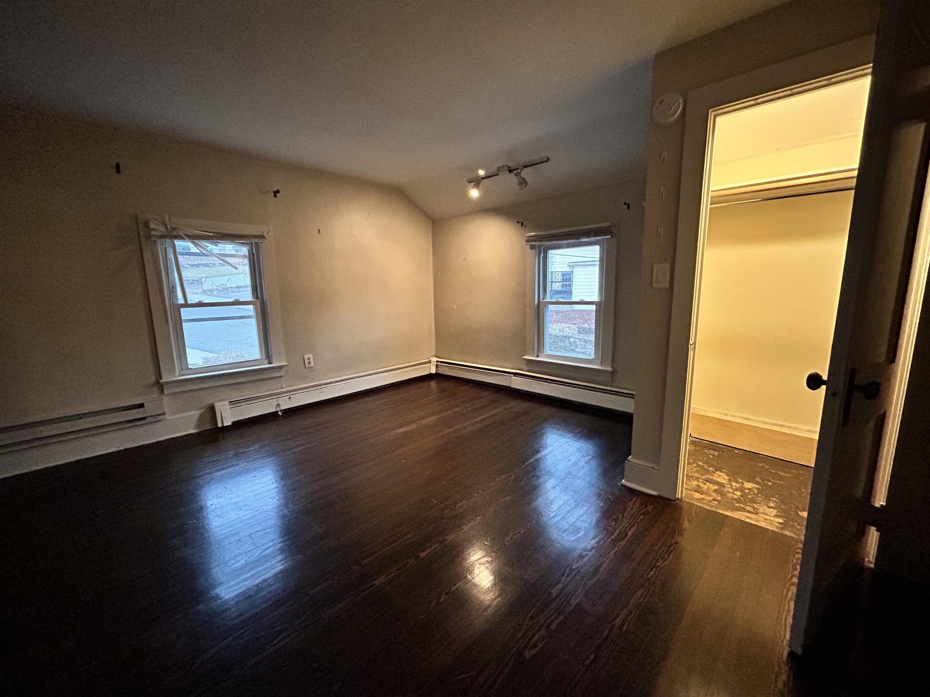 86 South Morris Street, Unit B Dover, NJ 07801 - Photo 10 of 11 an empty room with wooden floor and windows