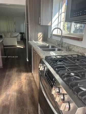 a kitchen with a stove a sink and a microwave