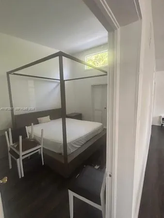 a bedroom with a bed and a mirror