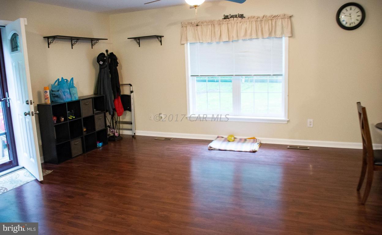 9703 Peerless Road Bishopville, MD 21813 - Photo 14 of 37 an empty room with wooden floor and window