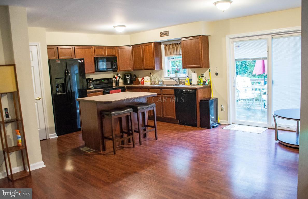 9703 Peerless Road Bishopville, MD 21813 - Photo 8 of 37 a kitchen with stainless steel appliances granite countertop a refrigerator and a stove top oven