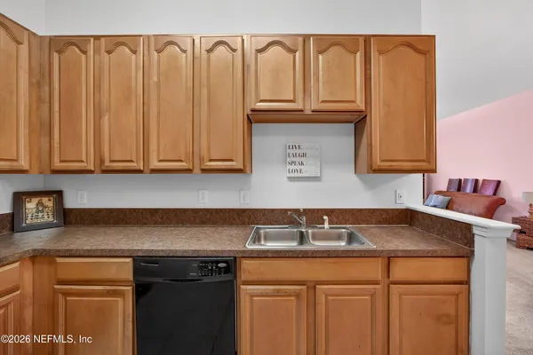 a kitchen with granite countertop a sink and a cabinets