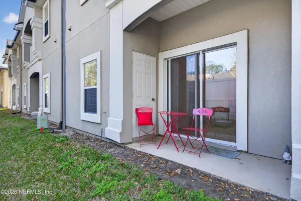 a view of a backyard with a table and chairs