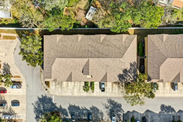 an aerial view of a house with a yard