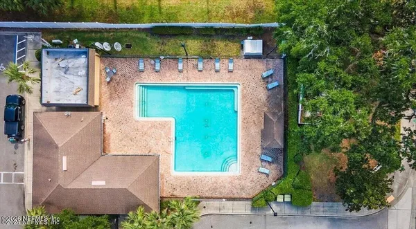 an aerial view of a house with a yard and potted plants