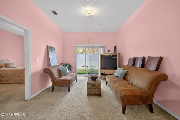 a living room with furniture and a large window