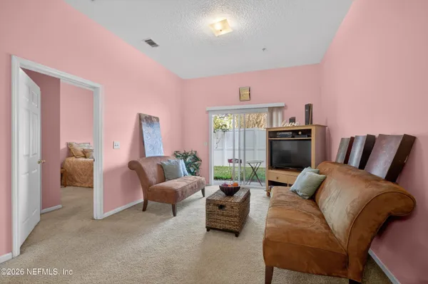 a living room with furniture and a large window