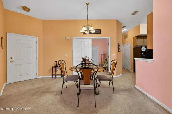 a dining room with furniture and window
