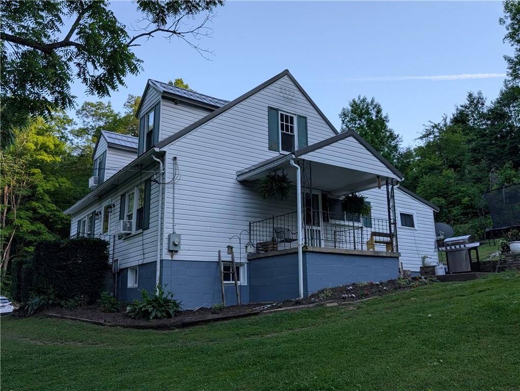 205 Woods Road Ligonier, PA 15658 - Photo 19 of 32 a front view of a house with a garden and plants