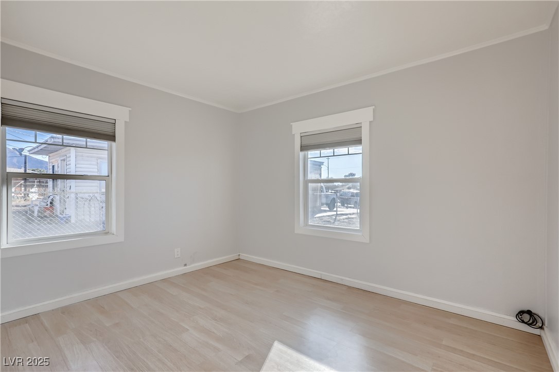 103 West Victory Road Henderson, NV 89015 - Photo 17 of 28 Bedroom with ornamental molding, light wood-style floors, and baseboards