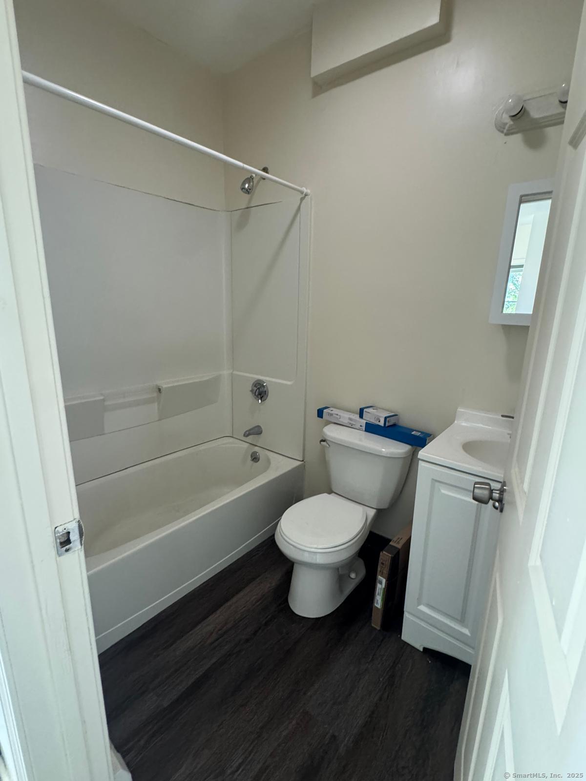 1053 East Main Street Bridgeport, CT 06608 - Photo 5 of 6 a bathroom with a toilet a sink and a bathtub