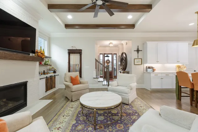 a kitchen with stainless steel appliances granite countertop a stove and a white refrigerator with white cabinets
